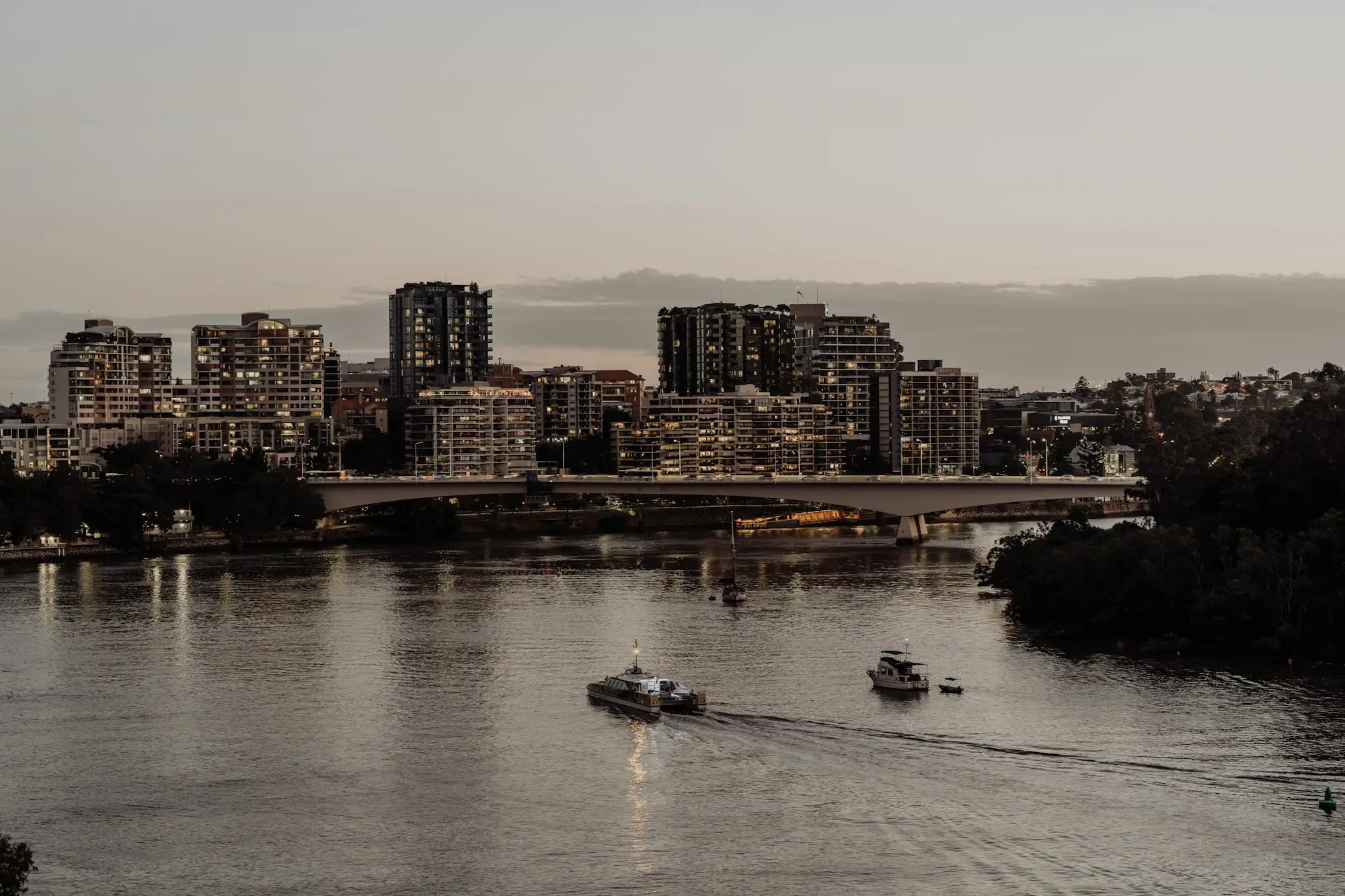 Boat on the Brisbane River with city buildings behind