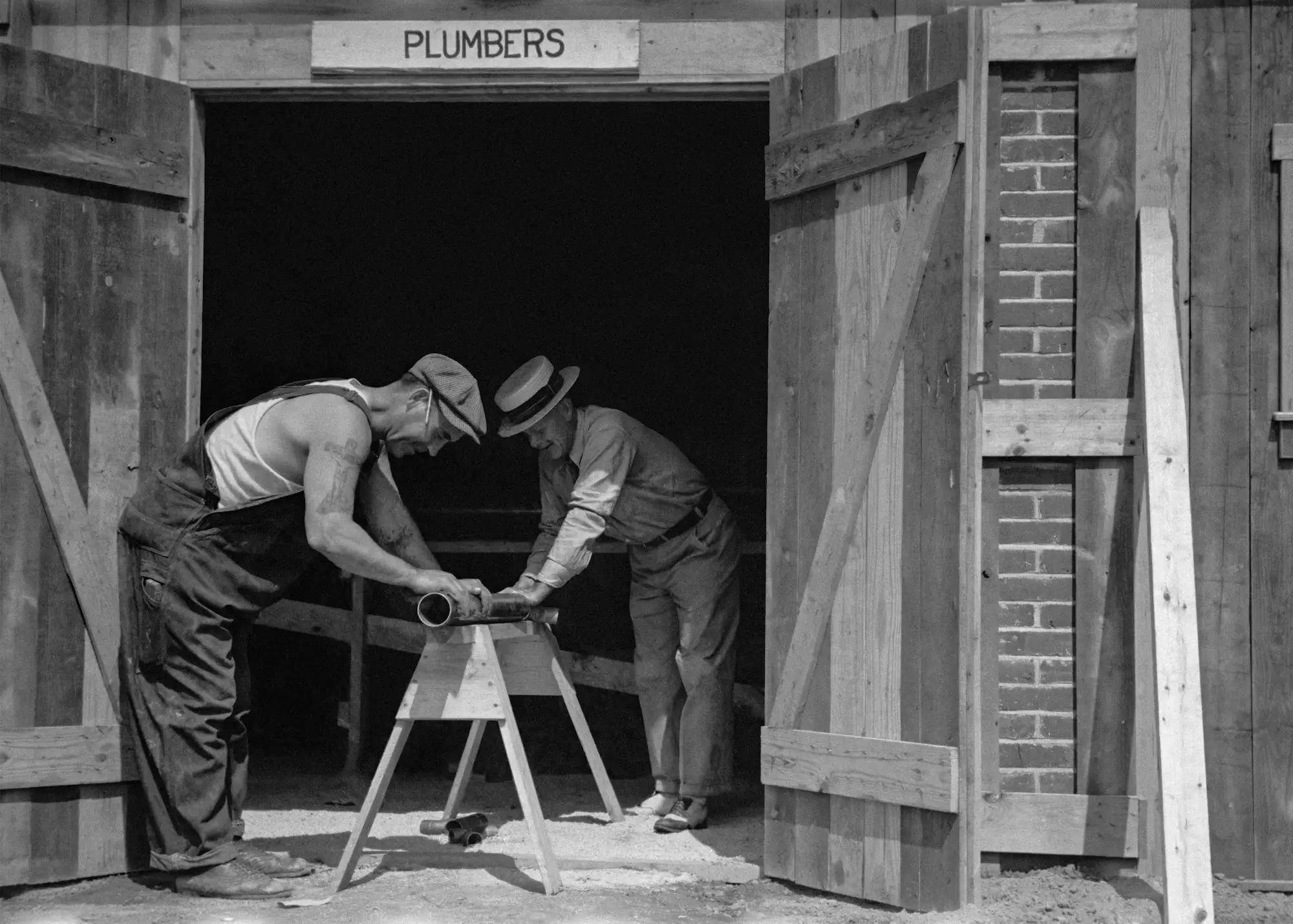 Two builders working on timber framing on a residential construction site