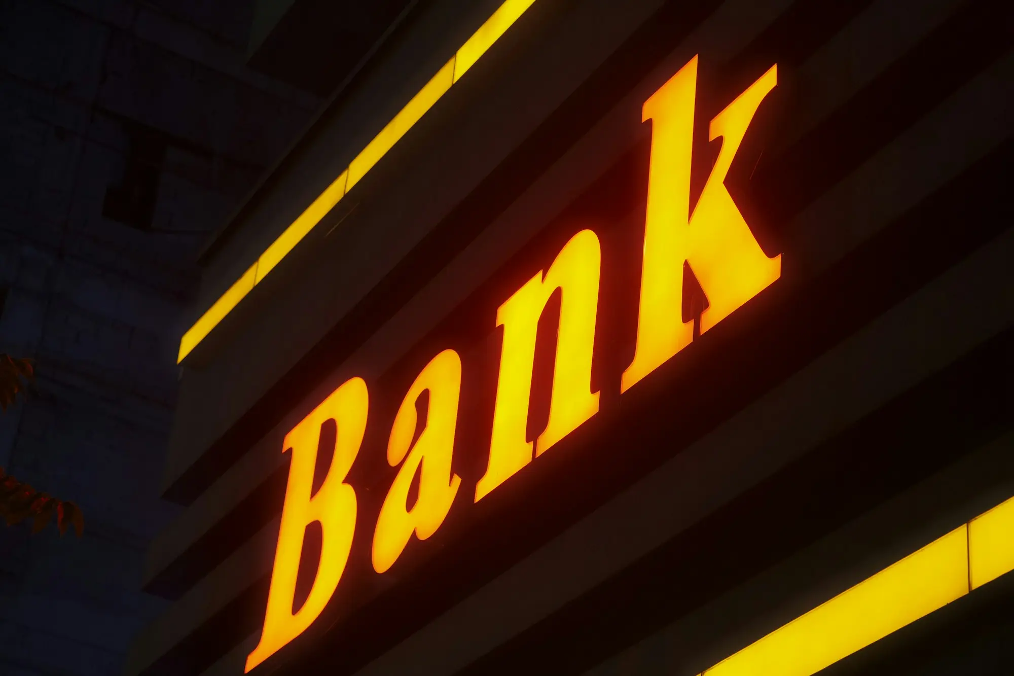 Bank sign lit up at night, for business owners who have been declined by their bank