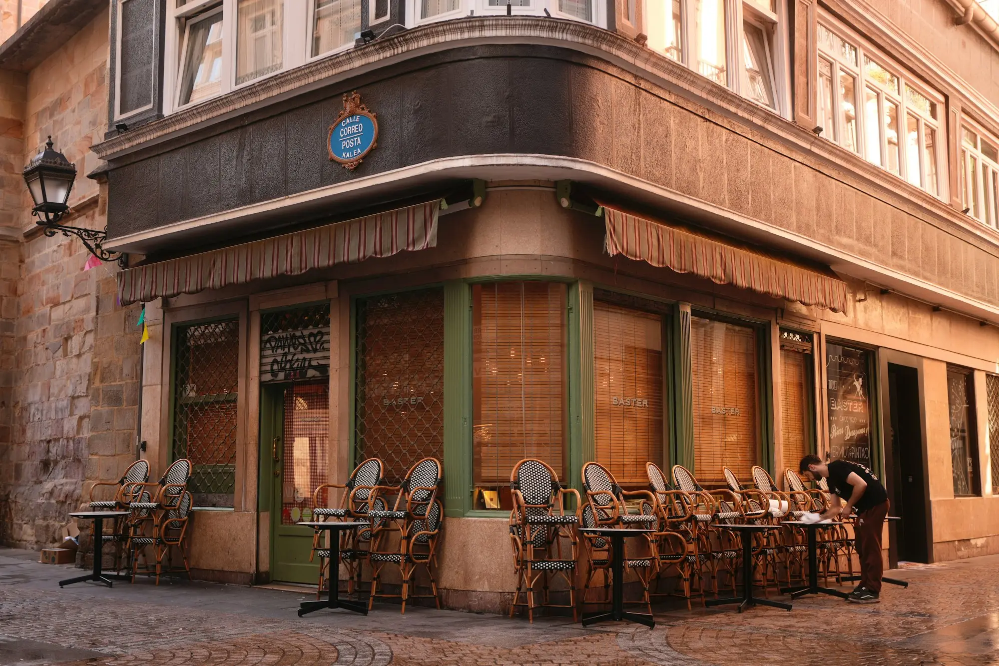 Outdoor cafe seating on a street in front of a historic building